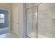 Tiled stand up shower with glass door inside a bathroom at 406 Westmarch Cir, Loganville, GA 30052
