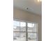 Bright room featuring a large window with white frames providing a view of the neighborhood at 406 Westmarch Cir, Loganville, GA 30052
