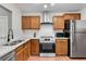 Well-equipped kitchen features stainless steel appliances, wooden cabinets, and granite countertops at 4234 Stillwater Dr, Duluth, GA 30096