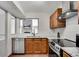 Modern kitchen with stainless steel appliances, light countertops, and an open view to the living room at 4234 Stillwater Dr, Duluth, GA 30096