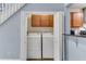 Convenient laundry room with washer, dryer, and overhead cabinets nestled beside the kitchen at 4234 Stillwater Dr, Duluth, GA 30096
