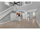 Bright living room boasts hardwood floors, a staircase, and neutral paint, with a glimpse of the kitchen area at 4234 Stillwater Dr, Duluth, GA 30096