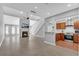 Open-concept living room with fireplace flows into kitchen, featuring hardwood floors, a ceiling fan, and lots of light at 4234 Stillwater Dr, Duluth, GA 30096