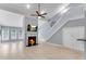 Cozy living room featuring a fireplace, a flat-screen TV, hardwood floors, and access to the staircase at 4234 Stillwater Dr, Duluth, GA 30096