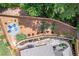 Aerial view of the backyard featuring a fire pit, custom stone patio and walkway, and privacy fence at 141 Alaina Rd, Canton, GA 30115
