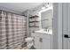 Hall bathroom with modern vanity, lighting, and shower curtain at 141 Alaina Rd, Canton, GA 30115