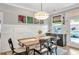 Dining room features a table, artwork, modern lighting, and a view of the exterior at 141 Alaina Rd, Canton, GA 30115