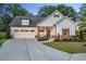 Beautiful two-story home with a well-manicured lawn and a spacious driveway at 141 Alaina Rd, Canton, GA 30115