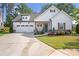 Charming single-Gathering home featuring white siding, a 2-car garage, and manicured landscaping at 141 Alaina Rd, Canton, GA 30115