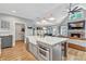 Modern kitchen with a center island, stainless steel appliances, and open layout to living area at 141 Alaina Rd, Canton, GA 30115
