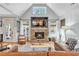 Bright living room with a brick fireplace, TV, leather sofa, and decor at 141 Alaina Rd, Canton, GA 30115