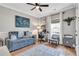 Comfortable home office with a sofa, desk, and ample natural light at 141 Alaina Rd, Canton, GA 30115