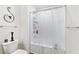 Bathroom featuring a toilet, tub with shower, decorative light fixture, and modern towel racks at 2033 Millstream Holw, Conyers, GA 30012