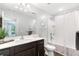 Bathroom features a tub with shower, wood-look flooring, dark wood vanity, and modern decorative accents at 2033 Millstream Holw, Conyers, GA 30012