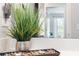 Bathroom counter with a decorative plant, rocks, candles, and a large mirror showing an open door and view at 2033 Millstream Holw, Conyers, GA 30012