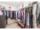 Walk-in closet featuring ample hanging space, metal shelving, and built-in storage solutions for organization at 2033 Millstream Holw, Conyers, GA 30012