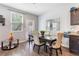 Dining area featuring a stylish table, upholstered chairs, and a view of the backyard at 2033 Millstream Holw, Conyers, GA 30012