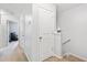 Bright hallway on the second floor with white doors and carpeted floors, leading to various rooms at 2033 Millstream Holw, Conyers, GA 30012