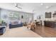 Open living room with hardwood floors, neutral carpet, and stylish furnishings under lots of natural light at 2033 Millstream Holw, Conyers, GA 30012