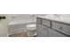 This bathroom features a combination of a bathtub and shower, toilet, and vanity with storage at 387 Skylar Se Way, Atlanta, GA 30315
