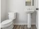 Powder room featuring a pedestal sink, tile floors, and modern fixtures at 387 Skylar Se Way, Atlanta, GA 30315