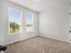 Bright bedroom with carpeted floors and two large windows at 387 Skylar Se Way, Atlanta, GA 30315
