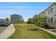 Well-maintained exterior of townhomes with lush landscaping, a community lawn and ample parking at 387 Skylar Se Way, Atlanta, GA 30315