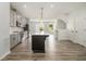 Open kitchen featuring an island, modern appliances, and hardwood floors at 387 Skylar Se Way, Atlanta, GA 30315