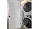 A laundry room with a stacked washer and dryer setup, providing convenience and space-saving design at 387 Skylar Se Way, Atlanta, GA 30315