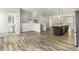 Open living room featuring hardwood floors, view of kitchen, and half bath at 387 Skylar Se Way, Atlanta, GA 30315