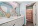 Bathroom with double vanity, floral wallpaper, and unique lighting at 408 Honeybee Ln, Canton, GA 30115
