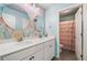 Bright bathroom featuring dual sinks and colorful wallpaper at 408 Honeybee Ln, Canton, GA 30115