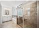 Bright bathroom featuring tiled floors, a soaking tub, and glass enclosed shower at 408 Honeybee Ln, Canton, GA 30115
