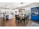 Well-lit dining area adjacent to kitchen with modern light fixture, view of backyard, and built-in blue buffet at 408 Honeybee Ln, Canton, GA 30115
