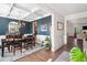 Open dining area with dark blue accent wall, chandelier, and hardwood floors at 408 Honeybee Ln, Canton, GA 30115