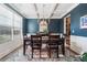 Sophisticated dining room with blue accent wall, coffered ceiling, and large window offering natural light at 408 Honeybee Ln, Canton, GA 30115