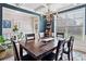 Bright dining room featuring a large table, stylish rug, and a view of the backyard at 408 Honeybee Ln, Canton, GA 30115