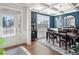 Elegant dining room with coffered ceiling, stylish chandelier, and plenty of natural light at 408 Honeybee Ln, Canton, GA 30115