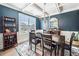 Well-appointed dining room with a large window, stylish furnishings, and a decorative mirror, creating a refined atmosphere at 408 Honeybee Ln, Canton, GA 30115