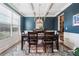 Formal dining room boasts a large window, decorative chandelier, and dark wood furniture over a colorful rug at 408 Honeybee Ln, Canton, GA 30115