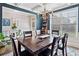 Sunlit dining room with a large wooden table, six chairs, a decorative rug, and stylish furnishings, perfect for gatherings at 408 Honeybee Ln, Canton, GA 30115