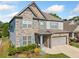 Attractive home with a stone and siding exterior, a two-car garage, and a neatly landscaped front yard at 408 Honeybee Ln, Canton, GA 30115