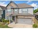 Inviting two-story home with stone and siding, complete with a two-car garage and a lovely front garden at 408 Honeybee Ln, Canton, GA 30115