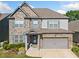 Beautiful two-story home featuring stone accents, siding, and blue shutters enhancing its curb appeal at 408 Honeybee Ln, Canton, GA 30115