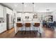 Open-concept kitchen with stainless steel appliances, granite counters, island with seating, and hardwood floors at 408 Honeybee Ln, Canton, GA 30115