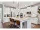Bright kitchen boasts white cabinets, stainless steel appliances, a large island, and stylish pendant lighting at 408 Honeybee Ln, Canton, GA 30115
