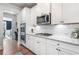 Kitchen area featuring white cabinets, granite countertops, stainless steel appliances, and subway tile backsplash at 408 Honeybee Ln, Canton, GA 30115