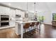 Modern kitchen with an island with barstool seating, stainless appliances, and opens to an informal dining area at 408 Honeybee Ln, Canton, GA 30115