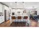 Bright, modern kitchen features a large island with seating, stainless steel appliances, and sleek, white cabinets at 408 Honeybee Ln, Canton, GA 30115