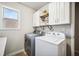 Laundry room featuring a washer, dryer, cabinets and a window at 408 Honeybee Ln, Canton, GA 30115